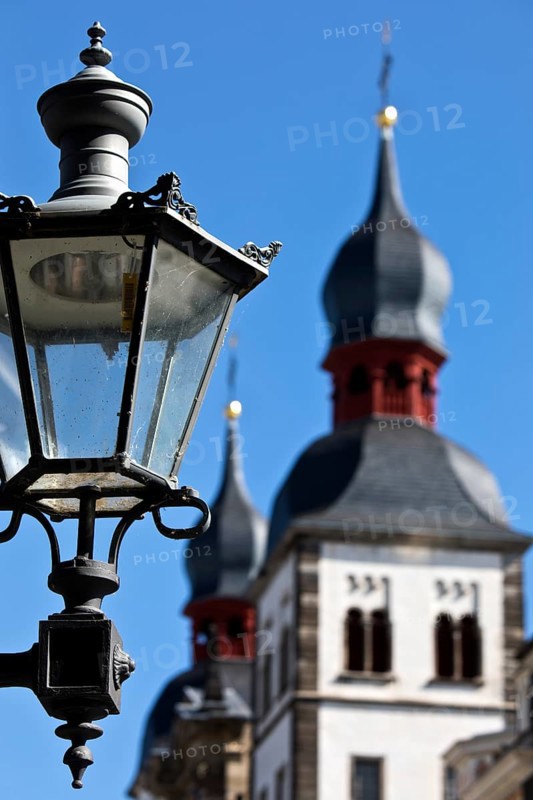 Historic alleyway lamp in front of the steeples of the Namen-Jesu-Kirche in Bonngasse, Bonn, North Rhine-Westphalia, Germany