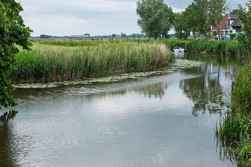 Damsterdiep canal in the village of ten Post, province of Groningen, Netherlands