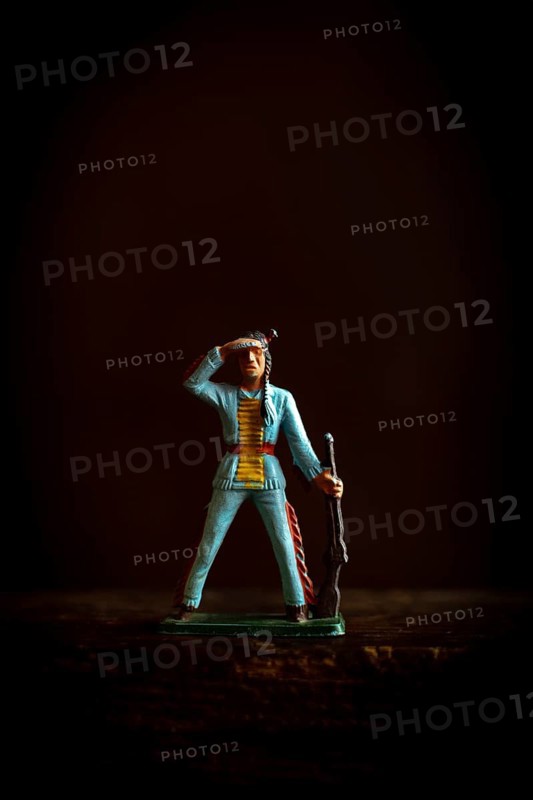 Intricate Native American Indian figure toy figurine in a blue uniform confidently salutes while holding a rifle