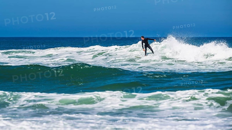 Surfer riding a wave on Contis beach, Saint Julien en Born, Saint-Julien-en-Born, Landes, France