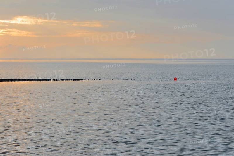 Evening mood at the Wadden Sea, stone groyne with red buoy, North Sea, Norddeich, Lower Saxony, Germany