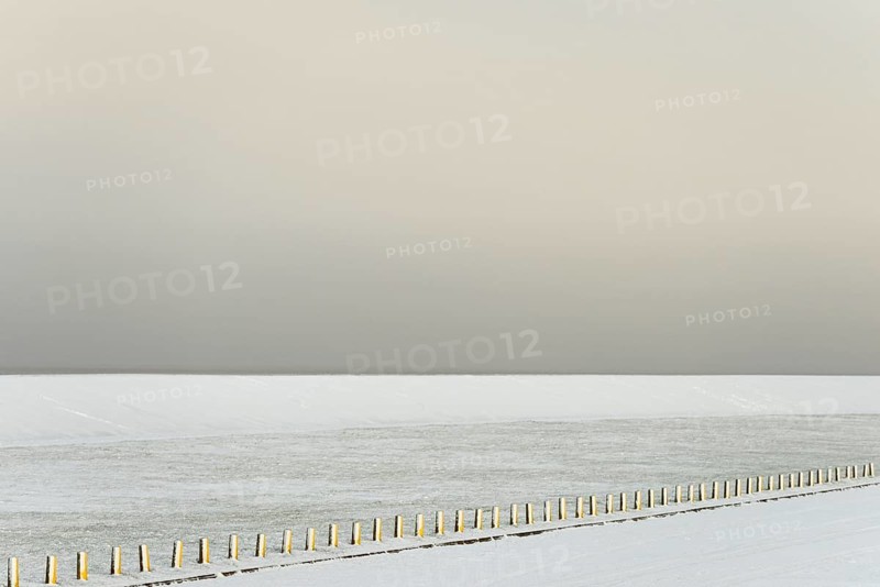 Winter day, onset of winter, snow-covered dyke and boundary piles, North Sea, Norddeich, Lower Saxony, Germany