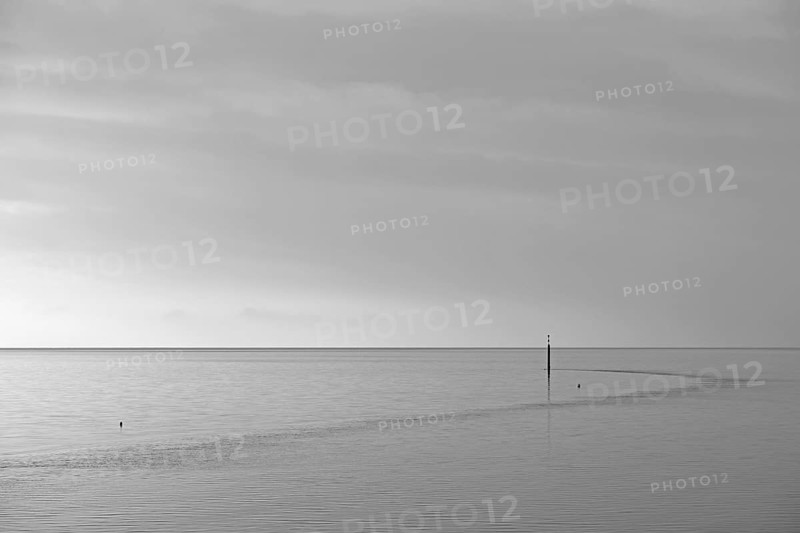 Wadden Sea at rising water, stone groyne with sea mark, black and white, North Sea, Norddeich, Lower Saxony, Germany