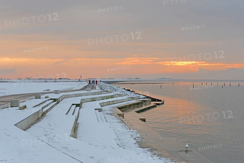 Evening atmosphere on the snow-covered beach promenade of Norddeich, North Sea, Lower Saxony, Germany