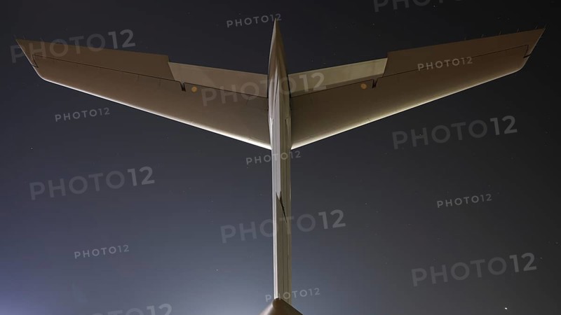 Close-up view of an airplane tail and wings against a clear twilight sky, captured from behind