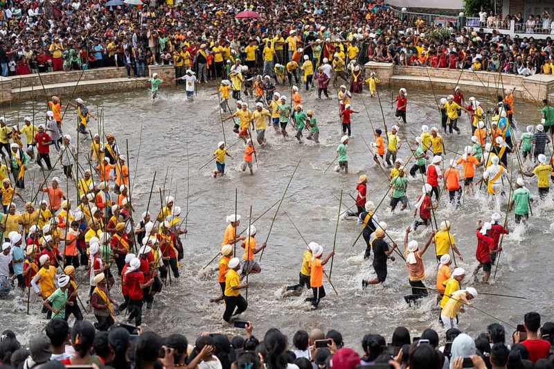 People from the Pnar community march in a circle as they celebrate an event organized to mark the Behdienkhlam festival in Jowai, India on July 14, 2025. Behdienkhlam is a vibrant annual festival celebrated by the Pnar (Jaintia) community of Meghalaya, especially in Jowai, to drive away plague and diseases and to pray for a good harvest. Observed in July after the sowing season, it features traditional rituals, offerings to ancestral spirits, and the grand procession of beautifully decorated bamboo structures called rots, which are later immersed in a sacred muddy pool known as Ka Aitnar