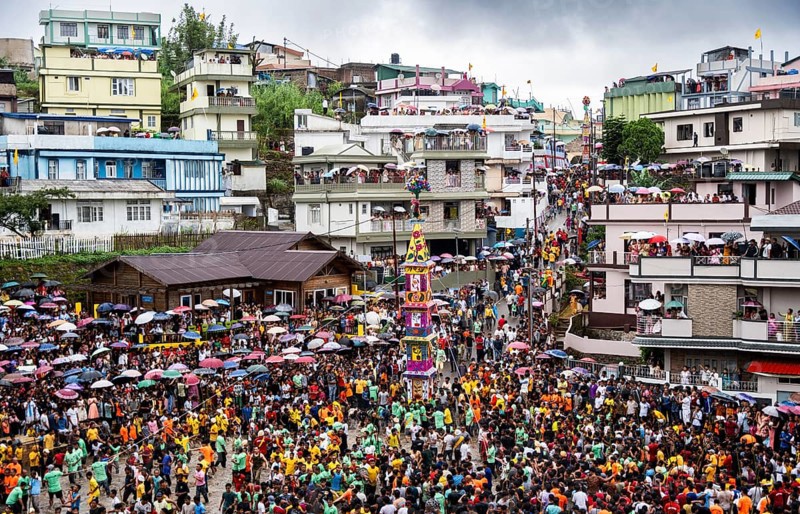 People from the Pnar community march in a circle around a Rot as they celebrate an event organised to mark the Behdienkhlam festival in Jowai, India on July 14, 2025. Behdienkhlam is a vibrant annual festival celebrated by the Pnar (Jaintia) community of Meghalaya, especially in Jowai, to drive away plague and diseases and to pray for a good harvest. Observed in July after the sowing season, it features traditional rituals, offerings to ancestral spirits, and the grand procession of beautifully decorated bamboo structures called rots, which are later immersed in a sacred muddy pool known as Ka Aitnar