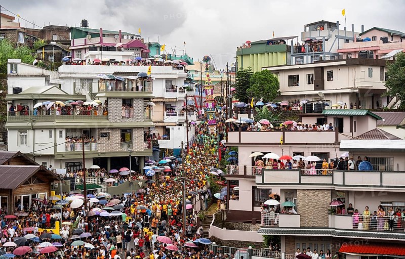 People from the Pnar community emjoy the Behdienkhlam festival from rooftop in Jowai, India on July 14, 2025. Behdienkhlam is a vibrant annual festival celebrated by the Pnar (Jaintia) community of Meghalaya, especially in Jowai, to drive away plague and diseases and to pray for a good harvest. Observed in July after the sowing season, it features traditional rituals, offerings to ancestral spirits, and the grand procession of beautifully decorated bamboo structures called rots, which are later immersed in a sacred muddy pool known as Ka Aitnar