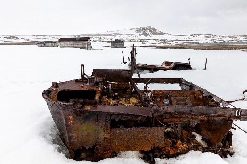 Former research station, rusty vehicle, wooden hut, Kinvika, Muchinsonfjord, Spitsbergen, Svalbard