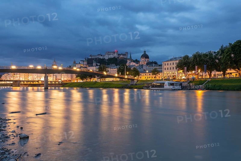 The city of Salzburg with the Salzach shines in the first light of summer morning