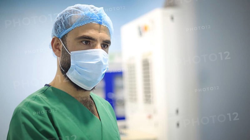 A patient and surgeon in the operating room during ophthalmic surgery