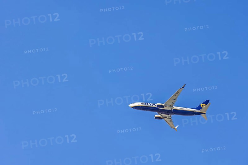 Ryanair passenger plane flying in a blue sky, Mallorca, Spain