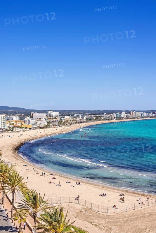 Aerial view at a sand beach with sunbathing tourists by a tourist resort by the sea a sunny summer day, Can Pastilla, Mallorca, Spain