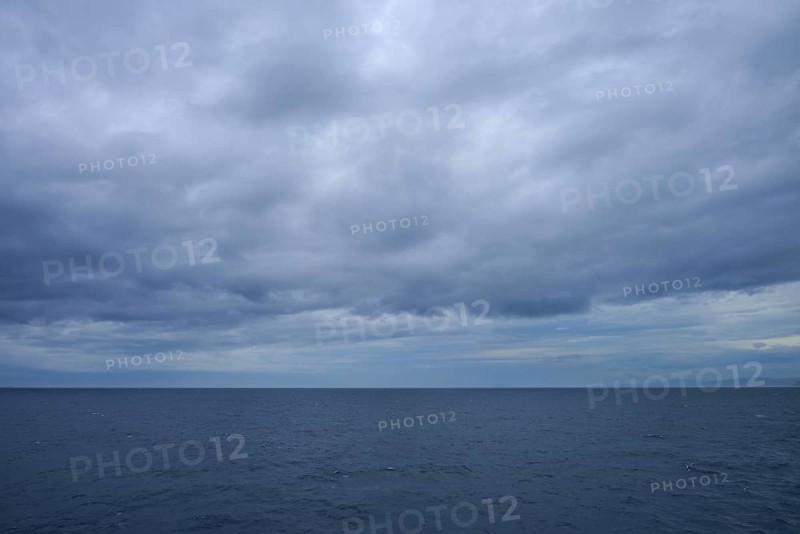 The sea stretches as far as the horizon under a cloudy sky, summer, Cook Strait, North Island, South Island, New Zealand
