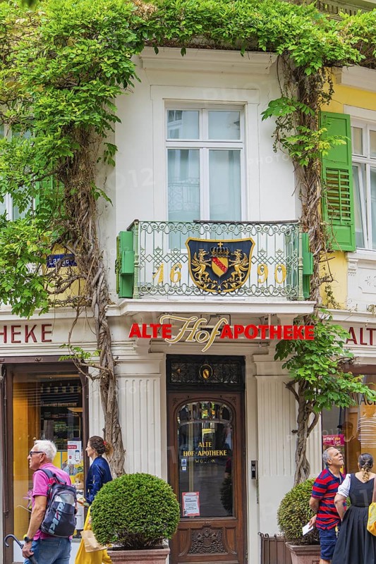 Historic pharmacy building with overgrown façade in the city, Baden Baden, Germany