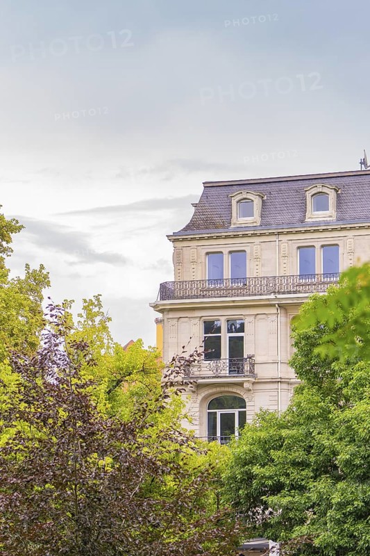 Classic building with richly decorated façade and windows, surrounded by trees, Baden Baden, Germany