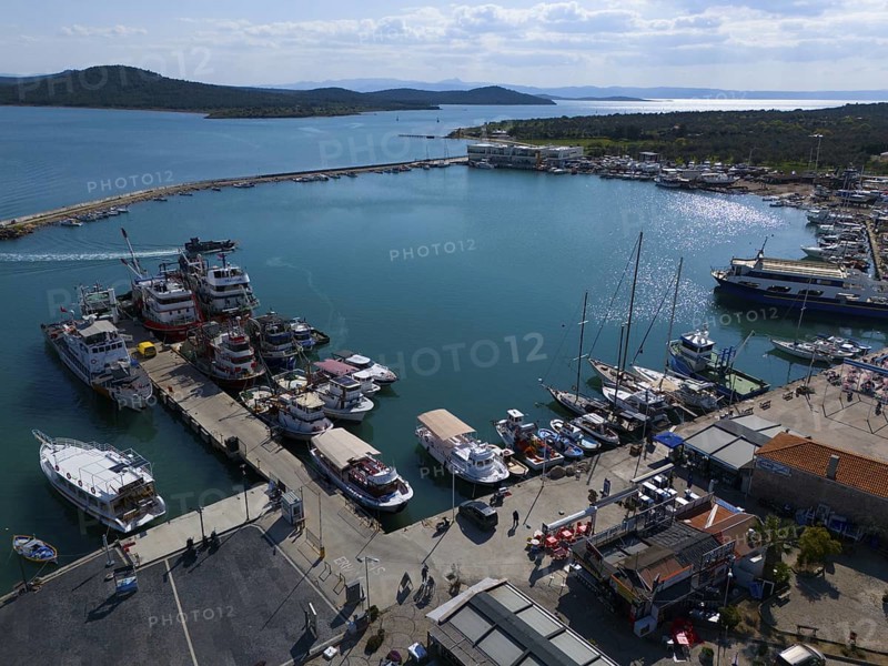 Sunny harbour with boats and yachts, surrounded by azure blue water and landscape, aerial view, Alibey, Alibey Adasi Island, Ayvalik, Turkey
