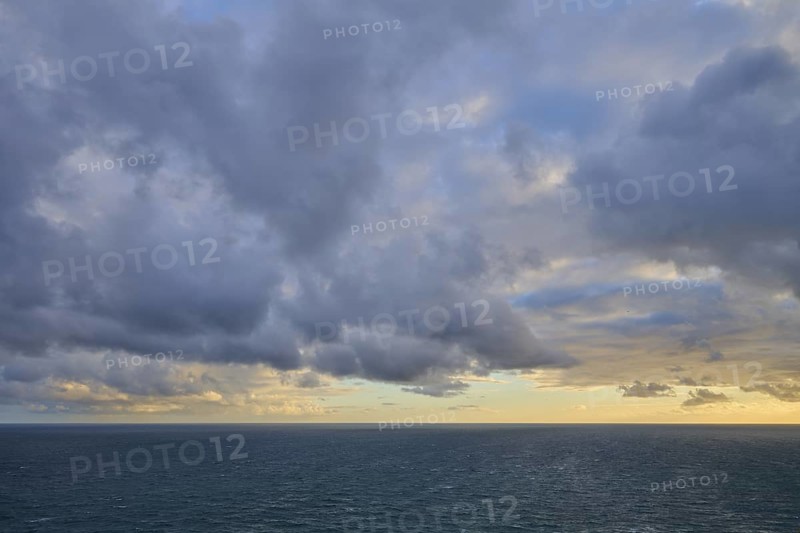 Cloudy sky over a calm, wide ocean at sunset, summer, Nugget Point Lighthouse, Ahuriri Flat, Otago, South Island, New Zealand