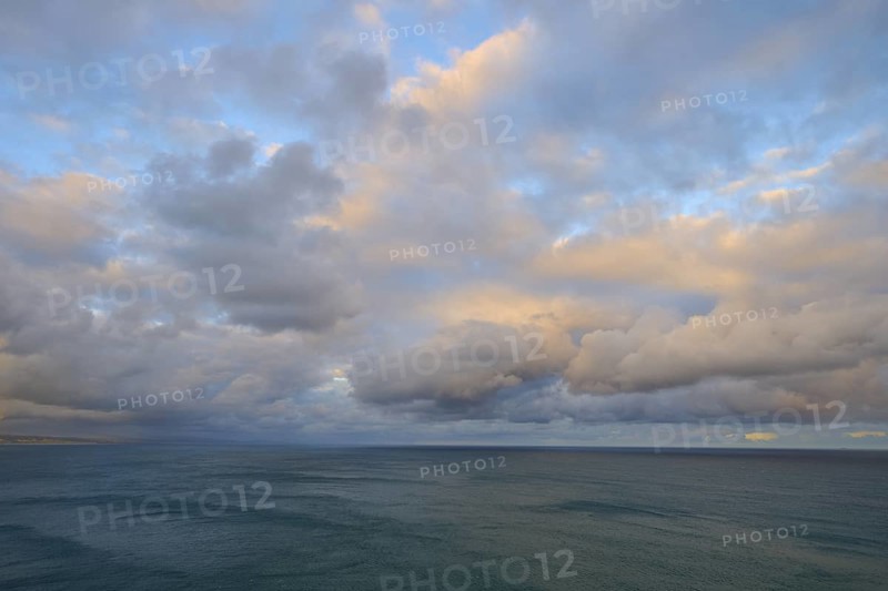 View of the sea under a sky with soft pastel colours at sunset, summer, Nugget Point Lighthouse, Ahuriri Flat, Otago, South Island, New Zealand