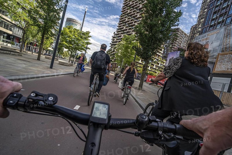 Cycle along the Jaarbeursplein, south of Utrecht Central, HBF, on the central cycle path in the city centre of Utrecht, lanes for pedestrians, cyclists and vehicles are separated, heavy cycle traffic, Netherlands