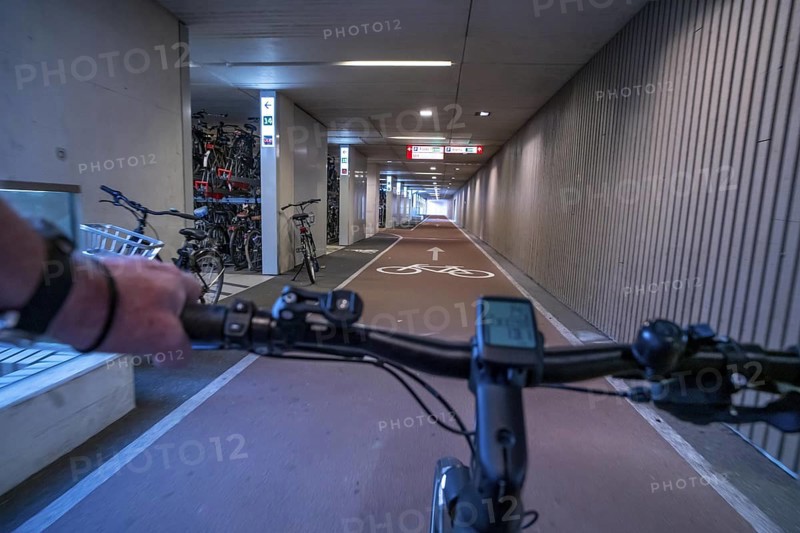 Ride your bike into and out of the bicycle car park at Utrecht Centraal station, Stationsplein, over 13, 000 parking spaces, considered the largest bicycle car park in the world, over 3 underground floors, Utrecht, Netherlands