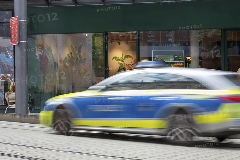 (Photomontage) Passing police car in the city