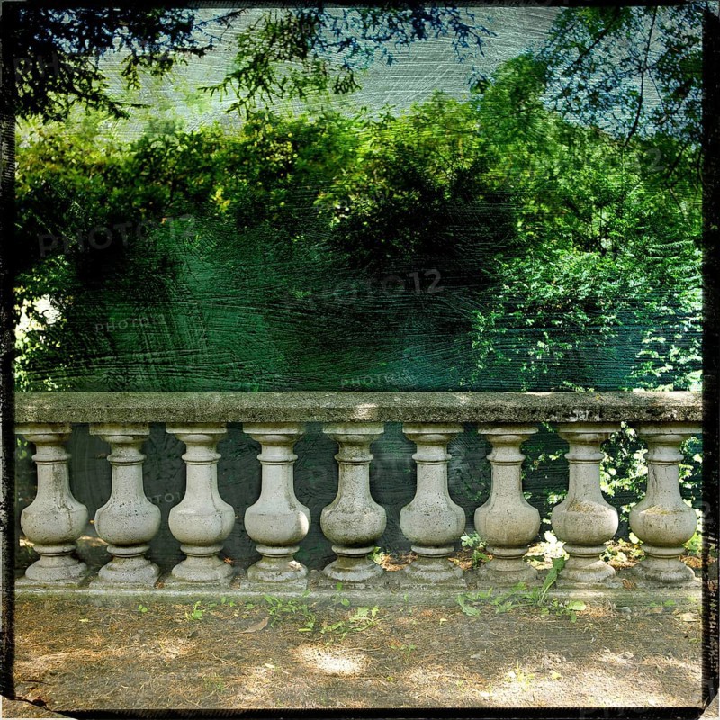 A garden balustrade exhibits a rich textured effect, framed by lush greenery and a captivating view of the Tempest Sea. The scene reflects tranquil nature and classic design. France