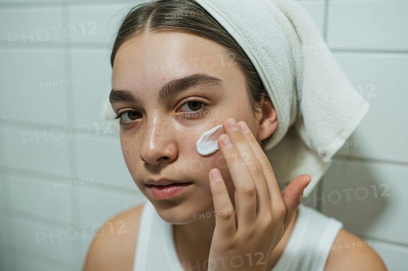 Teenage girl applying skin cream in bathroom. Honest daily skincare and self-care routine. Generative ai, AI generated