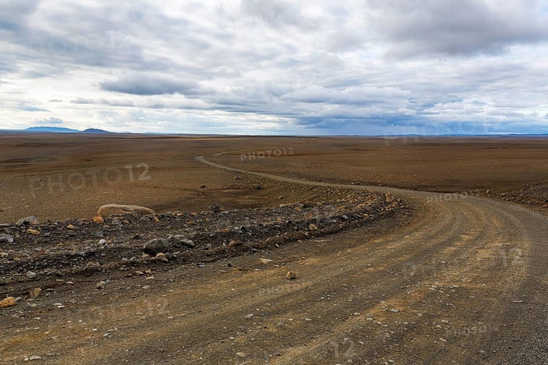 Highland road F-35, gravel track Kjalvegur Kjölur leads through barren stony volcanic landscape, desert, lava field, plateau, Icelandic highlands, Suðurland, Sudurland, Iceland