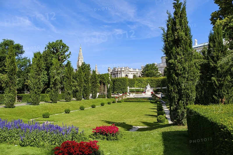 Vienna Volksgarten with a view of the famous Sisi Monument with the Town Hall Tower and the Burgtheater in the background, Vienna, Austria