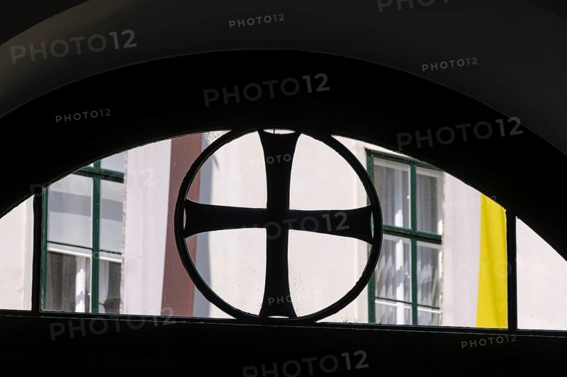 Black paw cross in the skylight of the entrance to the Deutschordenshaus in Vienna, Austria, for editorial use only