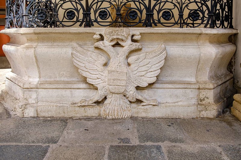 Heraldic double-headed eagle on the fountain (Schweizerhofbrunnen) in the inner courtyard of the Swiss Wing of the Vienna Hofburg Imperial Palace, Vienna, Austria, for editorial use only