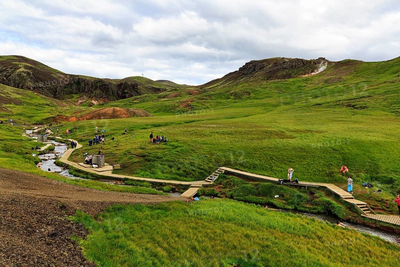 Tourists, hikers bathing in a geothermally heated river, Reykjadalur bathing area, Hveragerði, Hveragerdi, Golden Circle, Ring Road, Iceland