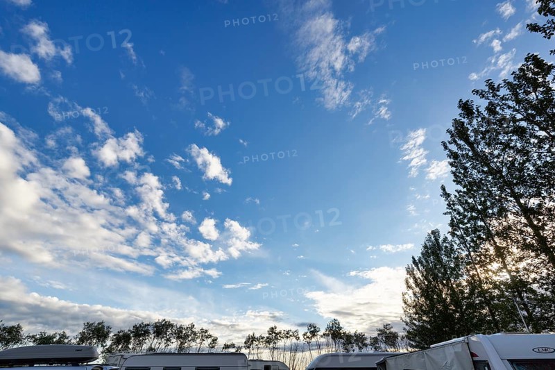 Cumulus, roofs of caravans and motorhomes on a campsite in the evening, Suðurland, Sudurland, Iceland