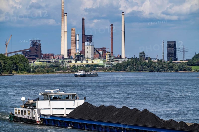 Industrial scenery of the ThyssenKrupp Steel steelworks in Duisburg-Bruckhausen, cargo ships on the Rhine, freighter Anja I, loaded with coal, blast furnaces, coking plant Schwelgern, Duisburg, North Rhine-Westphalia, Germany