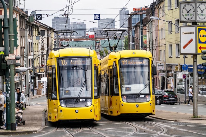 Ruhrbahn tram, on Altendorfer Straße, intersection Helenenstraße, in Essen-Altendorf, rush hour, traffic, skyline of the city centre of Essen, North Rhine-Westphalia, Germany