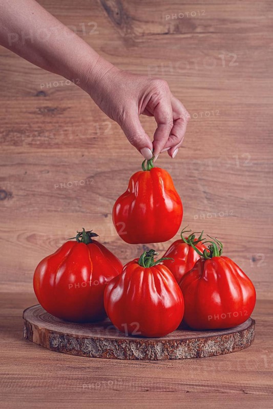 Khinkali tomatoes, on a wooden cutting board, wooden background, no people