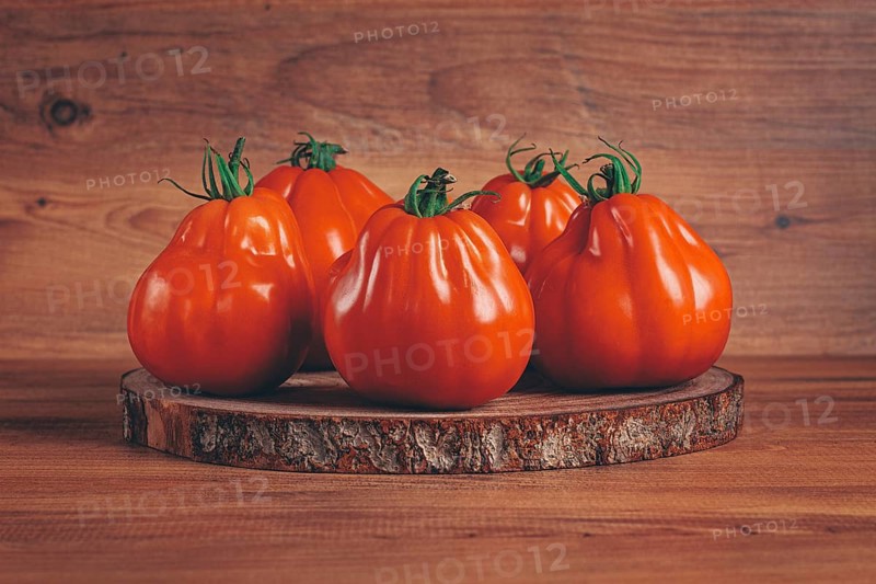 Khinkali tomatoes, on a wooden cutting board, wooden background, no people