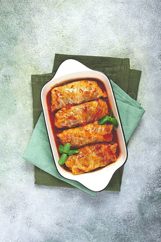 Stuffed cabbage rolls with minced meat, in tomato sauce, top view, without people, in the spotlight