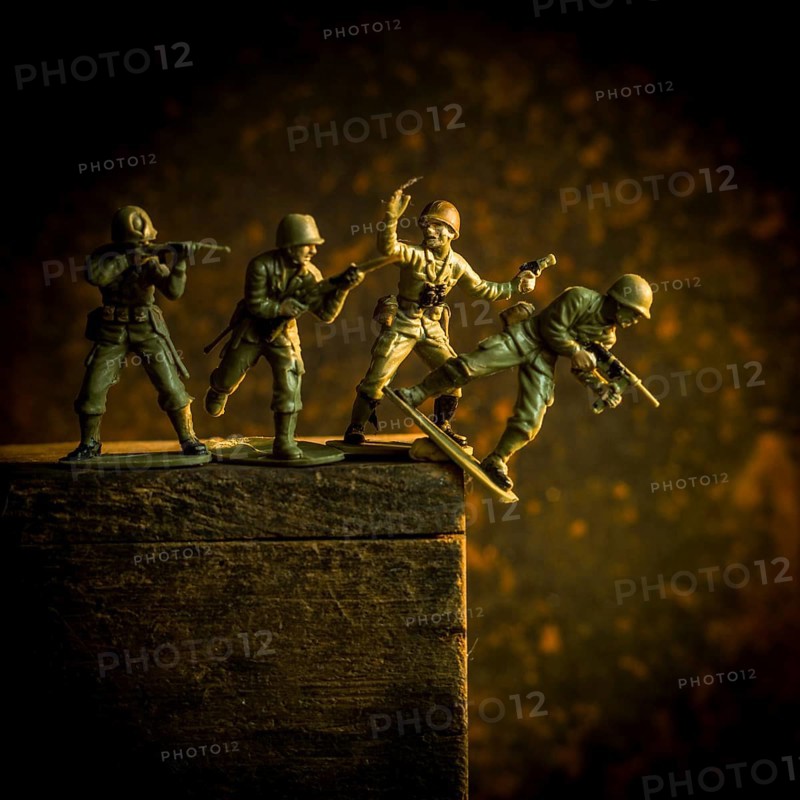 A group of toy soldiers are captured in motion as they navigate a steep incline, showcasing teamwork and strategy