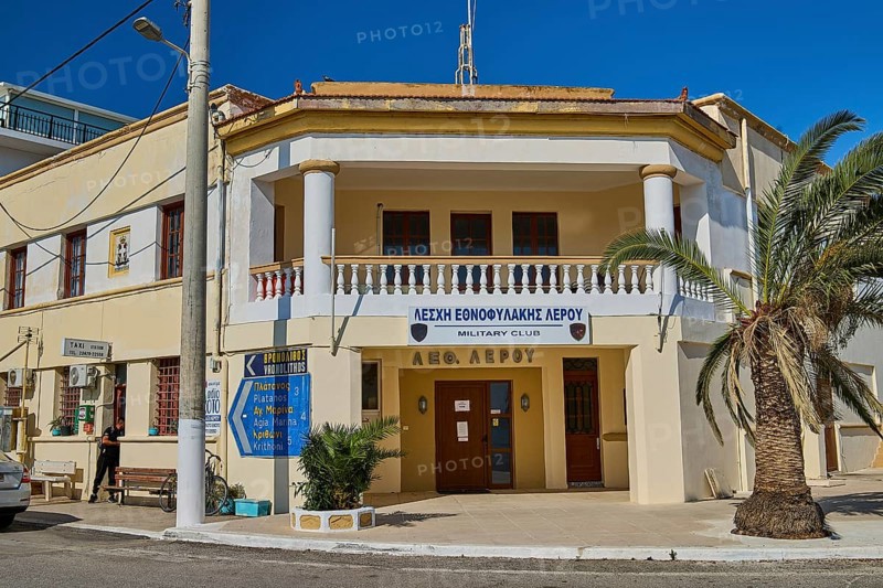 Military club building with columns and palm trees in a street scene, Armando Bernabiti, Historicism, Rationalism, Art Deco, Rationalism, Rodolfo Petraco, Fascism, Portolago, Lakki, Leros, Dodecanese, Greek Islands, Greece