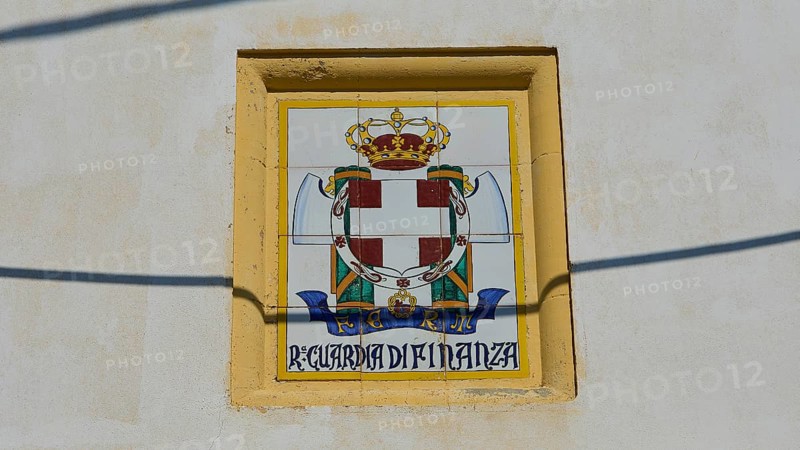 Guardia di Finanza, Coat of arms with crown and shield on beige background, textual elements, Armando Bernabiti, Historicism, Rationalism, Art Deco, Rationalism, Rodolfo Petraco, Fascism, Portolago, Lakki, Leros, Dodecanese, Greek Islands, Greece