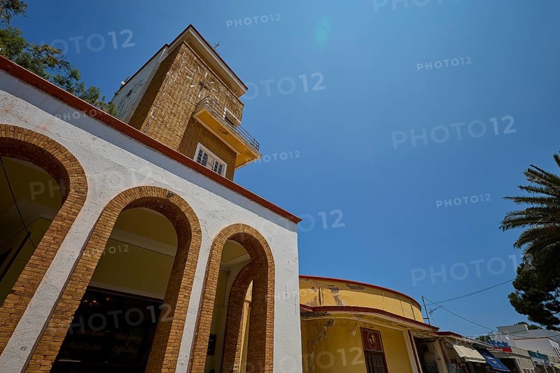 Market hall, Agora, Clock tower in clear style with arches and yellow elements, impresses in the sunlight, Armando Bernabiti, Historicism, Rationalism, Art Deco, Rationalism, Rodolfo Petraco, Fascism, Portolago, Lakki, Leros, Dodecanese, Greek Islands, Greece