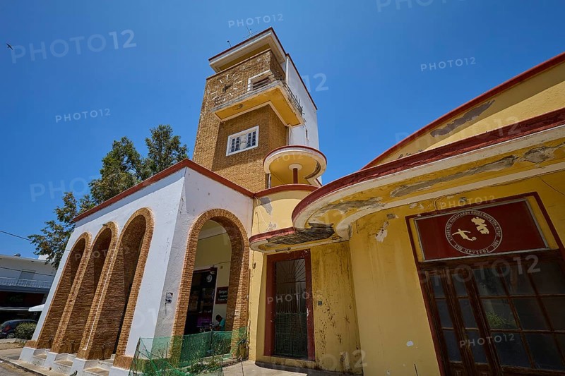 Covered market, agora, building with clock tower, characterised by red and yellow details, robust and steeped in history, Armando Bernabiti, historicism, rationalism, art deco, rationalism, Rodolfo Petraco, fascism, Portolago, Lakki, Leros, Dodecanese, Greek Islands, Greece
