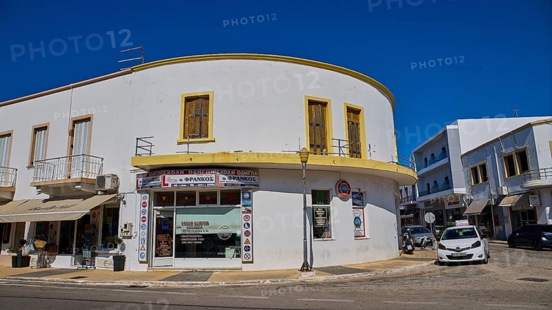 White corner building with shops and parked cars on the street, Armando Bernabiti, Historicism, Rationalism, Art Deco, Rationalism, Rodolfo Petraco, Fascism, Portolago, Lakki, Leros, Dodecanese, Greek Islands, Greece