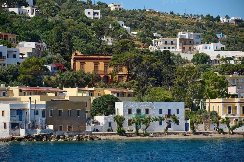 Colourful houses embedded in green vegetation on the coast, Lakki, Leros, Dodecanese, Greek Islands, Greece