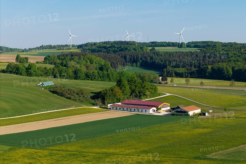 Idyllic rural scene with windmills, green fields and a farm under a blue sky, near Westerheim, Swabian Alb, Baden-Württemberg, Germany