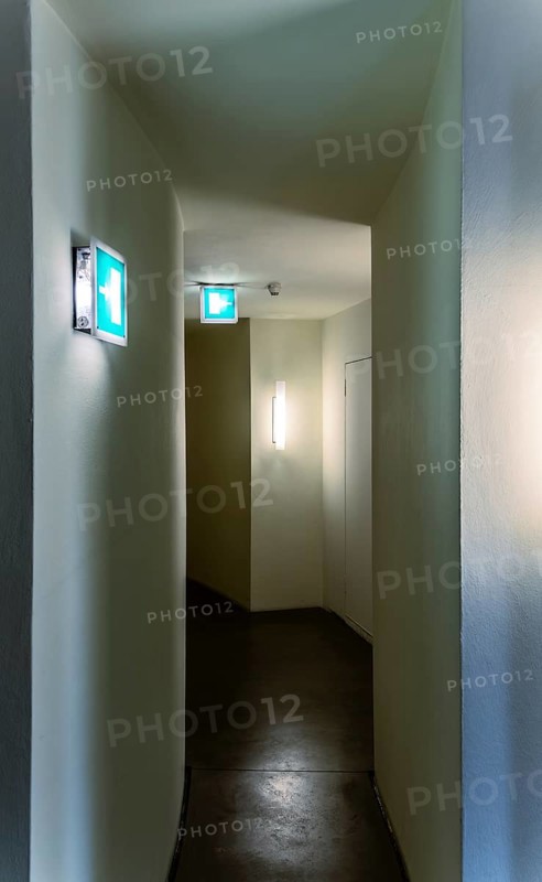 Emergency exit, narrow corridor in a public building, Berlin, Germany