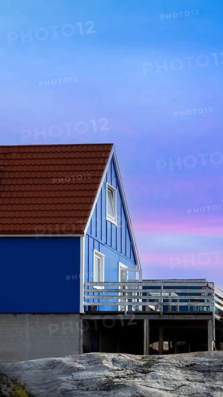 Typical architecture of Greenland Ilulissat with colored houses located near fjords and icebergs