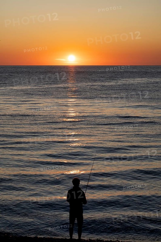 Angler fishing, silhouette, Étretat, sea, sunset, evening mood, atmospheric, Normandy, Seine-Maritime, France